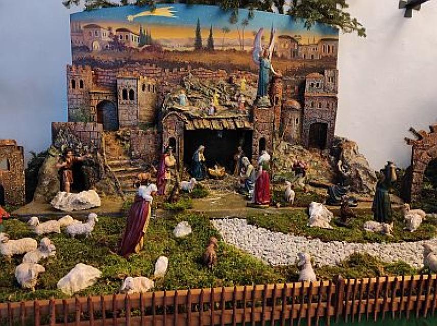 Krippendarstellung, die einer Burganlage ähnelt, mit Königen, Schafen und Maria, Josef mit Kind.