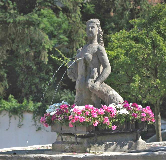 Der Jungfer-Kättl-Brunnen in Weißenbrunn ist legendär, denn zur Kirchweih Ende September sprudelt aus den Brüsten der Dame Bier statt Wasser!