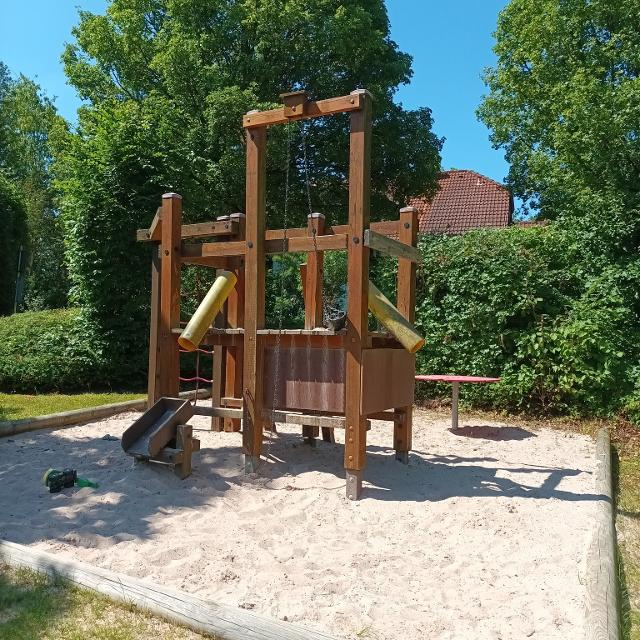 Das Bild zeigt ein Klettergerüst auis Holz mit Sandbereich. Dies befindet sich am Spielplatz in Unterrodach.