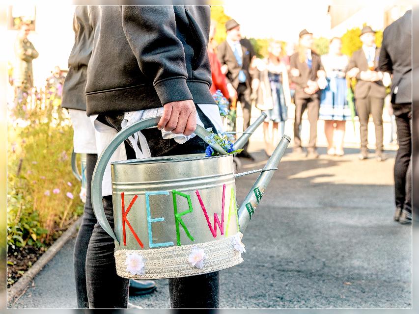 Das Bild zeigt einen Kirchweihburschen mit Gießkanne