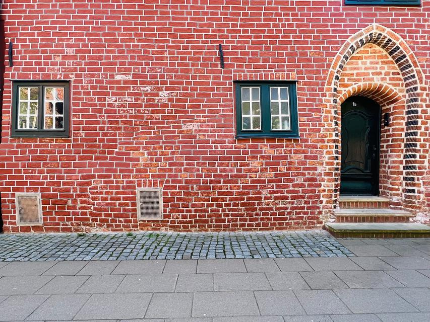 "Schwangeres" Haus aus rotem Backstein mit Wölbung 